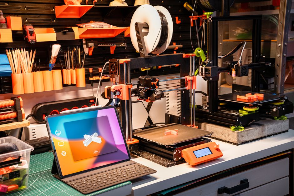 High-tech workshop with 3D printers and tablet