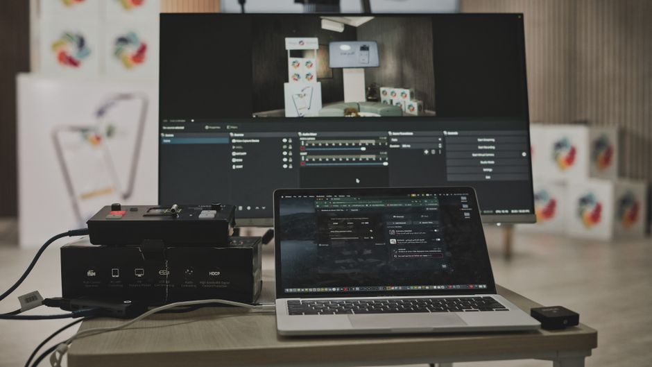 Multimedia setup featuring a laptop and a large monitor
